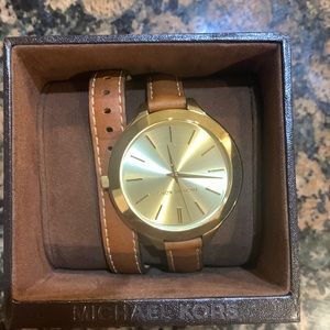 Gold watch face with camel toned leather wrap band.